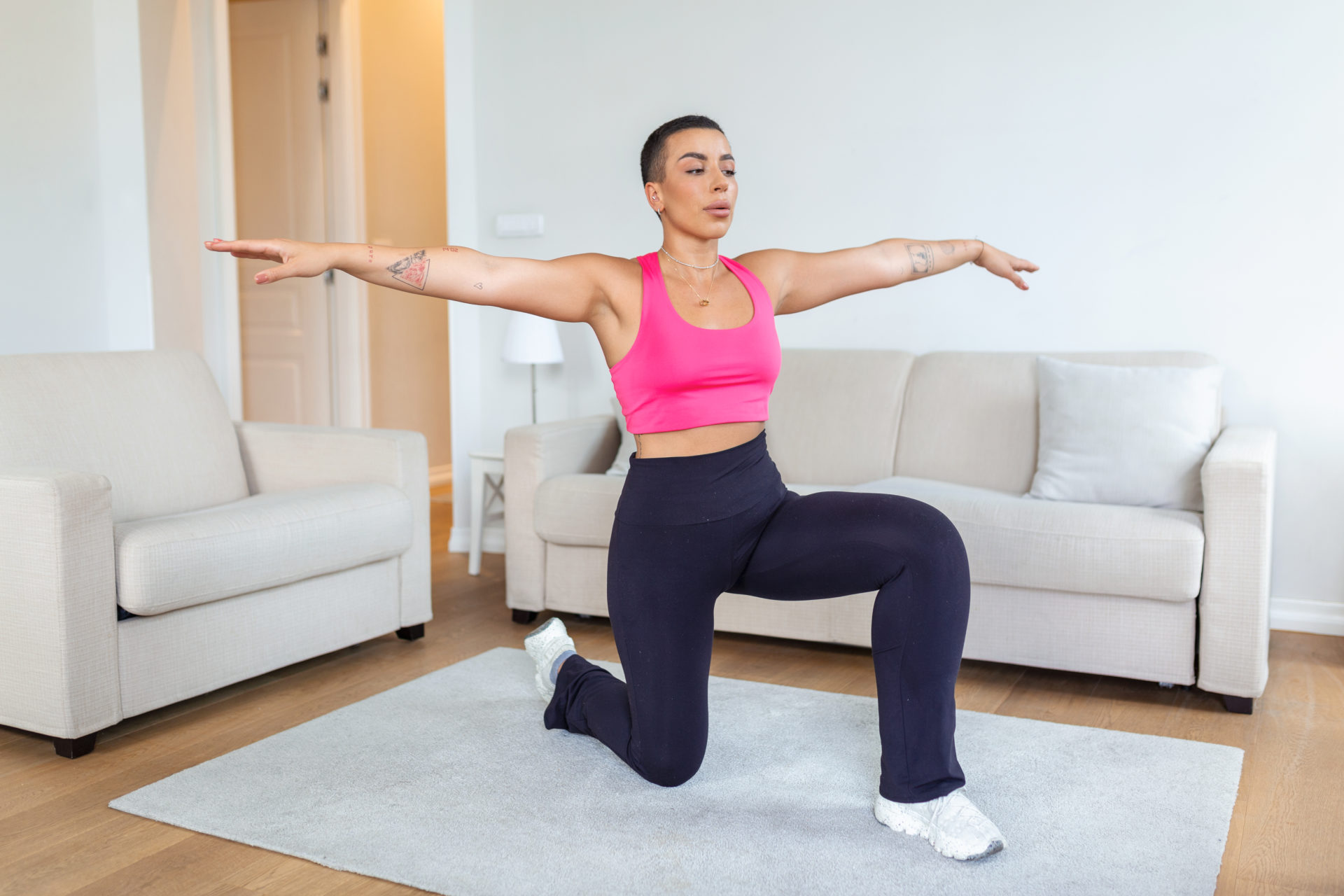 Warming Up Before Workout. Smiling Sporty Black Woman Training At Home Or Fitness Club Studio, Beautiful Female Stretching Legs After Exercises On Mat warming up before cardio