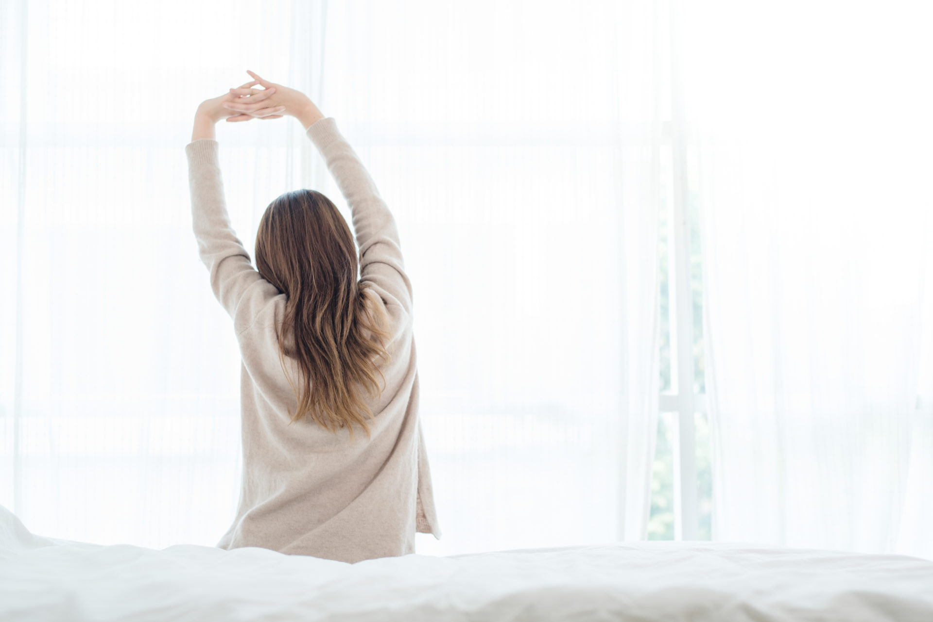 woman stretching her back in the morning