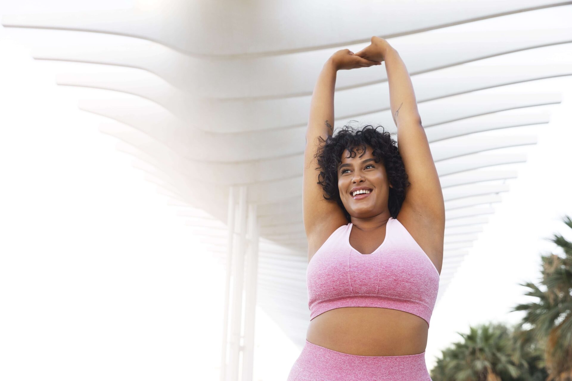 low-angle-smiley-woman-stretching-min-2 low-angle-smiley-woman-stretching-min-2